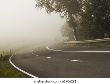 An Image Of A Road Covered In Fog