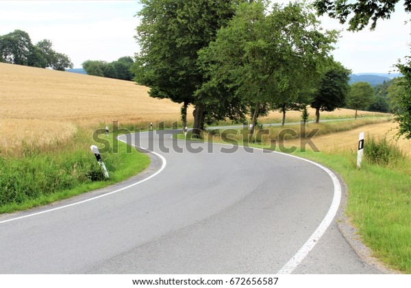 An image of a road -\
curve