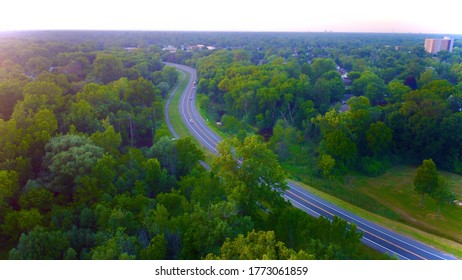 Image of road surrounded by trees￼.