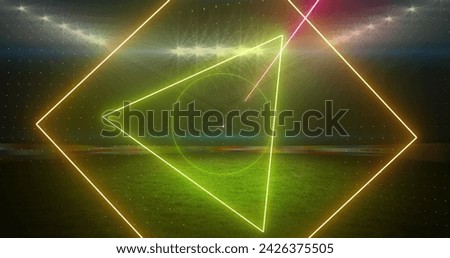 Image of rotating neon shapes and lights over floodlit sports field. sport, competition and communication technology concept, digitally generated image.