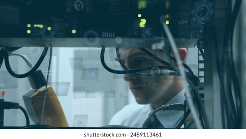 Image of round scanners and data processing over caucasian male engineer working at server room. Computer interface and business data technology concept