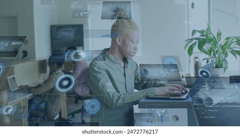 Image of round scanners over african american albino man using laptop at office. Computer interface and business technology concept - Powered by Shutterstock