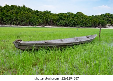 image of rowboat at riverside. rowboat at riverside nature. wooden rowboat at riverside
