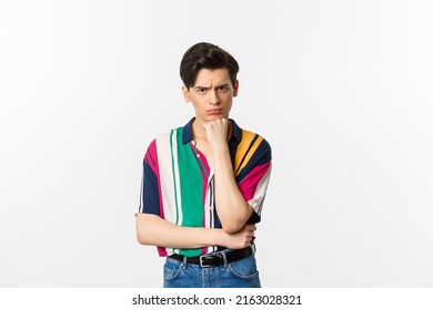 Image Of Sad Gay Man Looking At Camera, Sulking Displeased And Upset, Leaning On Hand, Standing Over White Background