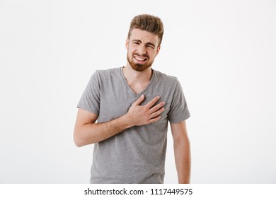 Image of sad young man with heartache standing isolated over white wall background. - Shutterstock ID 1117449575