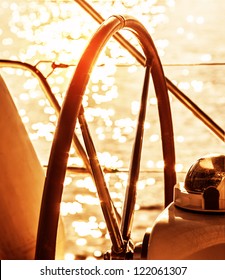 Image Of Sailboat Helm On Sunset, Steering Wheel Of Yacht, Rudder Of Vessel On Sunrise, Sea Transportation, Water Transport, Active Lifestyle, Summer Vacation, Ocean Cruise Concept