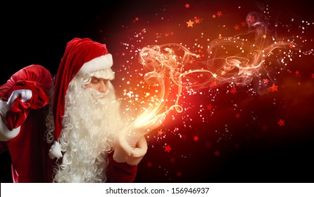 Image of Santa Claus in red costume against dark background