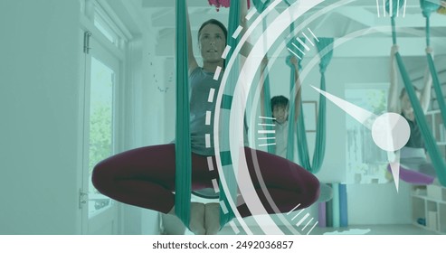 Image of scanner processing over diverse female instructor and teenage girls doing aerial yoga. Wellbeing, energy, fitness, processing, time and healthy lifestyle, digitally generated image. - Powered by Shutterstock