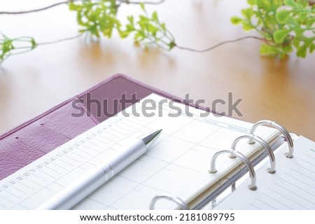 Image of schedule management of notebook and ballpoint pen