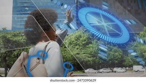 Image of scope scanning and data processing over african american woman waving. Global business, data processing and digital interface concept digitally generated image. - Powered by Shutterstock