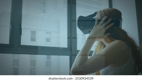 Image of scope scanning and data processing over woman wearing vr headset. digital interface, global connection and communication concept digitally generated image. - Powered by Shutterstock