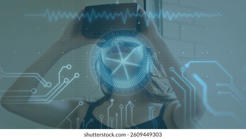 Image of scope scanning and data processing over woman wearing vr headset. global data processing, communication and global technology concept digitally generated image.