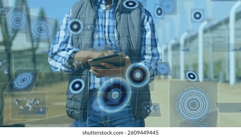 Image of scope scanning and data processing on screens over man using tablet. global connections, technology and digital interface concept digitally generated image.