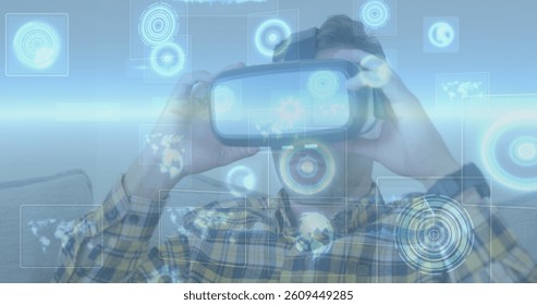 Image of scopes scanning over man wearing vr headset. global data processing, communication and global technology concept digitally generated image.