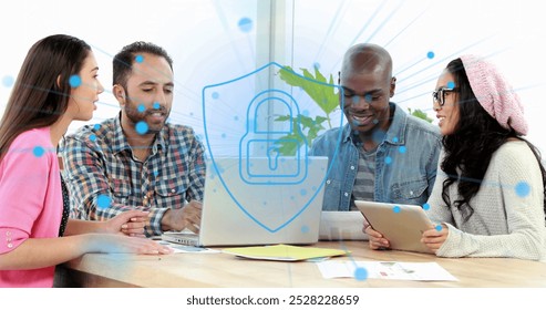 Image of security padlock icon against diverse colleagues discussing over a laptop at office. Cyber security and business technology concept - Powered by Shutterstock