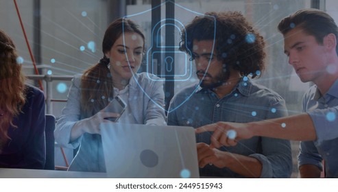 Image of security padlock icon over diverse colleagues using laptop and discussing at office. Cyber security and business technology concept - Powered by Shutterstock