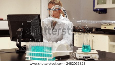 Image of security padlock icon over caucasian female scientist using computer at laboratory. Medical research and science technology concept