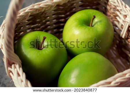 An image select focus close-up apple green fresh is fruit or food for health contain in a basket with light and shadow, relying on harvesting produce from the garden.