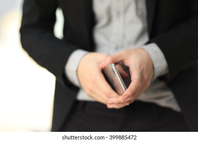 Image selective focus at hand of businessman working with smartphone, concept of successful business. - Shutterstock ID 399885472