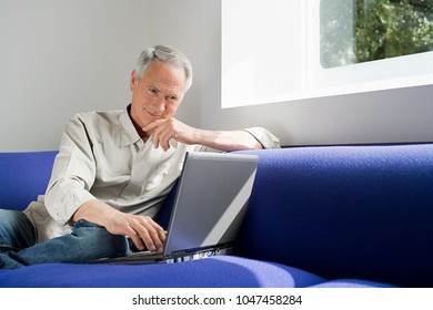 An Image Of A Senior Man Using A Laptop