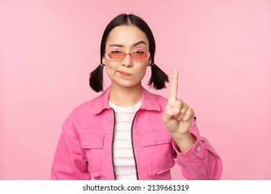 Image Of Serious, Stylish Asian Girl In Sunglasses, Showing Stop, Prohibit Gesture, Taboo Sign, Saying No, Standing Over Pink Background