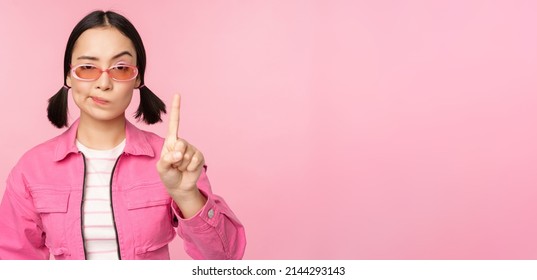 Image Of Serious, Stylish Asian Girl In Sunglasses, Showing Stop, Prohibit Gesture, Taboo Sign, Saying No, Standing Over Pink Background