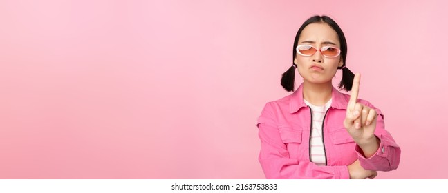 Image Of Serious, Stylish Asian Girl In Sunglasses, Showing Stop, Prohibit Gesture, Taboo Sign, Saying No, Standing Over Pink Background