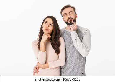 Image of serious thinking young loving couple isolated over white wall background looking aside. - Shutterstock ID 1067073155