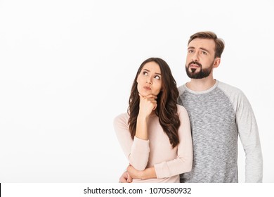 Image of serious thinking young loving couple isolated over white wall background looking aside. - Shutterstock ID 1070580932