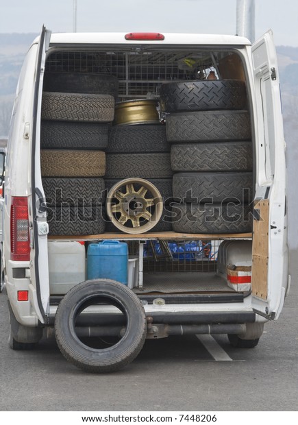 Image\
of a service truck carrying wheels for rally\
cars.