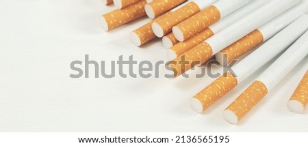 image of several commercially made cigarettes. pile cigarette on wooden. or Non smoking campaign concept, tobacco
