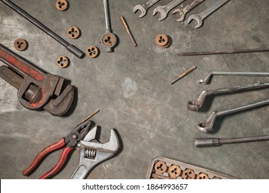 image of several workshop tools on the floor, wrenches, wrenches, pipe wrenches, pliers and bolts