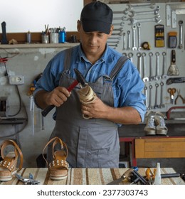 Image of a shoemaker repairing the sole of a woman's shoe. Manual and do-it-yourself work - Powered by Shutterstock