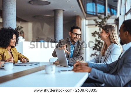 The image showcases professionals engaged in a collaborative meeting, highlighting teamwork, communication, and a productive office environment, captured within a contemporary workspace.
