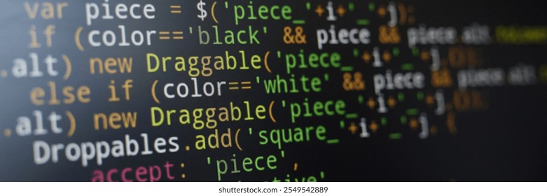 Image showing close-up view of JavaScript code written on dark computer screen. Various colorful syntax elements such as variables and operators are visible - Powered by Shutterstock