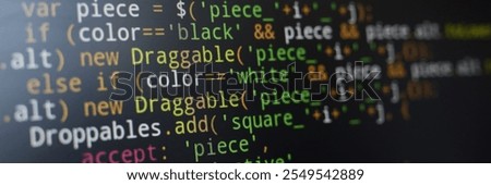 Image showing close-up view of JavaScript code written on dark computer screen. Various colorful syntax elements such as variables and operators are visible