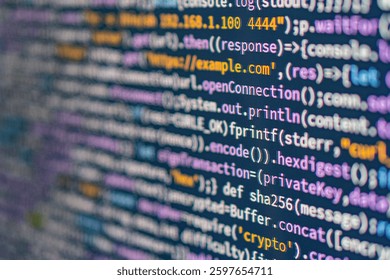 Image shows a close-up of a colorful coding text editor on a computer screen, with unreadable code The background is light grey