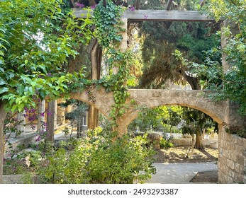 The image shows a close-up of a stone archway leading to a courtyard. The archway appears to be made of large, rough-hewn stones.   - Powered by Shutterstock