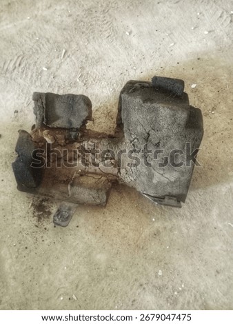 The image shows a damaged or worn engine mount. The engine mount serves to anchor the engine to the car's chassis and dampen engine vibrations so they don't reach the cabin.