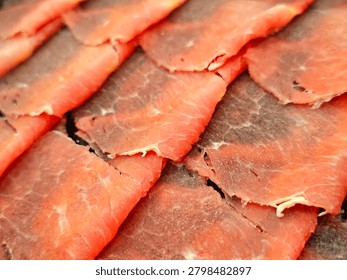 The image shows extra thinly sliced ​​Wagyu beef, thinly sliced ​​lean beef in an Asian style suitable for shabu-shabu and sukiyaki.