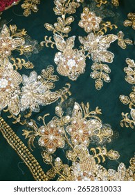 the image shows floral design pattern on a chiffon fabric with pearl, beads, crystal and sequins workwith zardozi techniques
for bridal and wedding dress shows the authentic South Asia textile work 