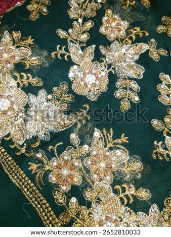 the image shows floral design pattern on a chiffon fabric with pearl, beads, crystal and sequins workwith zardozi techniques
for bridal and wedding dress shows the authentic South Asia textile work 