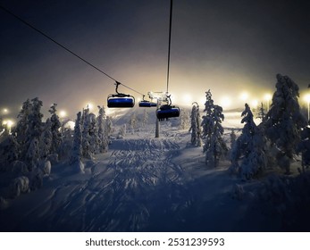 The image shows the landscape of the Levi ski resort in Lapland, where ski lifts operate in cold and misty weather. The ski slope invites skiers into the snowy terrain. - Powered by Shutterstock