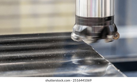 The image shows a machine tool precisely cutting or engraving a steel surface. The focus is on the interaction between the tool and the material, highlighting the precision of CNC machining.