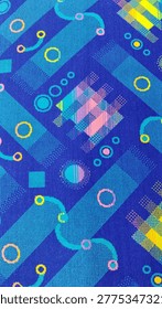 The image shows a patterned fabric, commonly referred to as moquette, which is typically used for seat upholstery on public transportation like buses or trains.
​The design is highly geometric and reminiscent of 