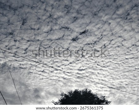 The image shows a stretch of white clouds visible above in the morning, but the cloud cover appears less bright.