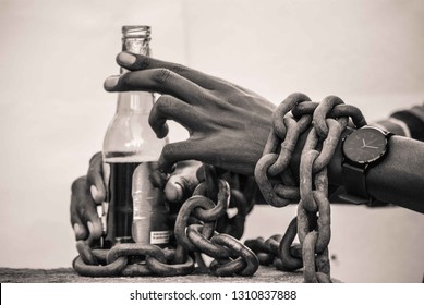 The Image Shows A Subject Who Is Chained To A Bottle. This In A Way Is Portraying The Adverse Effects Of Alcohol Abuse, Which Is Addiction. Hence You Became A Slave To Alcohol.