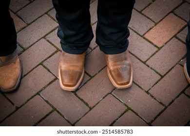 Image shows three pairs of dress shoes on a brick pavement, highlighting fashion and footwear. - Powered by Shutterstock