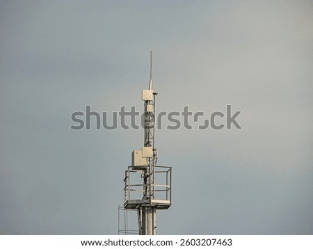 Image shows a tower with multiple structures, possibly communication equipment, on a clear day Tower has platforms for maintenance or access The text USER overlays the image