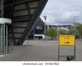 Image Of A Sign Direction To The Covid Vaccination Centre At The Hydro With The NHS Louisa Jordan Hospital In The Background. Image Was Taken 05.05.2021 In Glasgow, Scotland